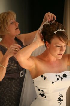 Mother of the bride helping her daughter prepare for her wedding day